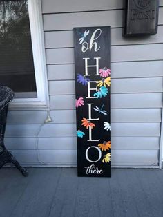 a sign that says oh hello there on the side of a house in front of a door