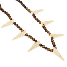 With semi precious, Tiger-Eye gemstones, the Wakanda inspired necklace mixes street and contemporary that brings versatility to any ensemble. The stainless steel link chains inside offers stability and quality while the 14K gold plated claws displays a vibrant shine. In addition, the custom clasps provides an easy but secure lock that adds a Wakanda inspired design. Gold Beaded Pendant Necklaces With Stones, Modern Gold Necklaces With Natural Stones, Luxury Gold Beaded Necklaces With Natural Stones, Modern Gold Necklace With Beaded Chain, Modern Gold Necklace With Natural Stones, Luxury Gold Beaded Necklace With Natural Stones, Modern Yellow Gold Jewelry With Stones, Gold Long Beaded Necklaces With Stones, Luxury Brass Gemstone Necklaces