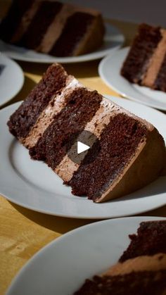 several slices of chocolate cake on white plates