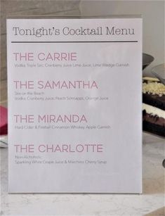 the menu for tonight's cocktail menu is displayed on a marble countertop next to a cake