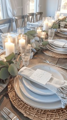 the table is set with candles and place settings