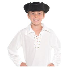 a young boy wearing a pirate hat and white shirt with his hands on his hips