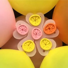 an arrangement of balloons and buttons in the shape of flowers