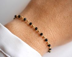 This Rosary Chain bracelet is made with Gold Plated chain adorned with black Cristal Glass beads and Gold plated Beads. ➵ Perfect to wear alone or for layering with more bracelets.➵ The bracelet length is ajustable thanks to 5 cm (2 in) extender chain.➵ Matching Black and Gold choker: https://www.etsy.com/fr/listing/706531342/collier-choker-ras-du-cou-chaine?ref=shop_home_active_7&crt=1 --*--*--*--*--*--*--*--*--*--*--*--*--*--*--*--*--*--*--∞ SIZE ∞- length: Adjustable bracelet - around 15 Beaded Chain Bracelet, White Beads Bracelet, Stackable Necklaces, Nickel Free Jewelry, Rosary Chain, Silver Chain Bracelet, Gold Choker, Modern Necklaces, Gold Plated Bracelets