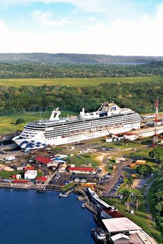 a large cruise ship docked at a dock in the middle of a body of water