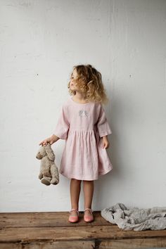 Tea dress is made of 100% soft medium weight linen.  Details: - Choose size and embroidery in the drop down menu - Colour: Baby pink - Composition: 100% Oeko-Tex certified linen - T shape - Gathered waist - Peach ribbon in the back - Medium weight linen - Linen care: machine wash gentle; tumble dry low, ironing optional - The price is for one dress, other pictured items are not included Light Pink Linen Dress, Handmade Pink Cotton Dress, Pink Linen Short Sleeve Dresses, Pink Short Sleeve Linen Dress, Pink Short-sleeved Linen Dress, Pink Tea, Thick Sweaters, Girls Dresses Summer, Linen Dresses