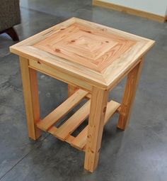 a small wooden table sitting on top of a cement floor