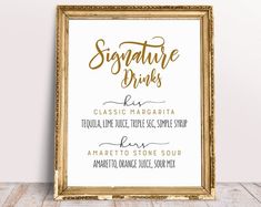 a gold framed sign that says signature drinks