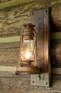 an old fashioned lantern hanging from the side of a wooden wall