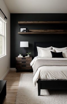 a bedroom with black walls, white bedding and wooden shelves on the wall above the bed