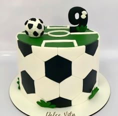 a soccer themed cake with the number nine on top and a ball in the middle