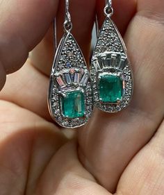 Specification:- Stone Details :- *Diamond Material : Cubic Zirconia ( CZ ) *Center Diamond Shape : Emerald *Center Diamond Dimension : 10*8 MM (2 Pcs.) *Center Diamond Weight : 7.58 CT *Side Diamond Dimension : 1.60, 1.70, 1.80, 1.90, 2.00, 2.20, 2.30, 2.60 MM *Diamond Color: White, Green *Diamond Clarity : VVS *Making Process: Handmade by our Experienced Staff. *Stamp: Our All Earring Stamped According to metal Purity (925 SIL). Custom Order:- *We do Accept Custom order. *Buyer can also request Fine Jewelry Emerald Pear-shaped Earrings, Pear-shaped Emerald Earrings Fine Jewelry, Classic Emerald Pear-shaped Earrings, Wedding Diamond Earrings With Emerald Accents, Classic Pear-shaped Emerald Earrings, Emerald Earrings With Diamond Accents, Emerald Diamond Earrings For Wedding, Fine Jewelry Cluster Drop Earrings, Emerald Drop Diamond Earrings For Wedding