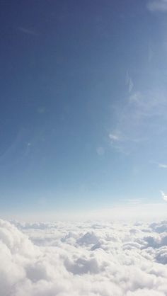 an airplane is flying high above the clouds