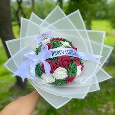 a bouquet of flowers is being held in someone's hand with the words happy birthday on it