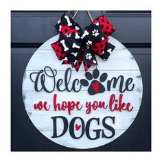 a sign that says welcome we hope you like dogs with a red bow on it