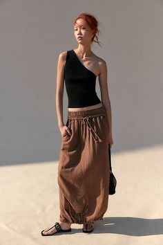 *The* perfect wear-everywhere skirt, this breezy style features a cinch band detail at the hem for added dimension. **Fit:** Mid-rise, parachute silhouette **Features:** Pull-on waistband with drawstring feature, back vented hem, banded hem, soft linen blend **Why We ❤ It:** Toughened-up with moto boots or off duty with simple sandals, you’ll be reaching for this from season to season. | Daphne Maxi Skirt by Free People in Brown, Size: XS Drawstring Skirt Outfit, Brown Long Skirt Outfit, High Class Dress, Parachute Silhouette, Roman Plaster, Brown Long Skirt, Long Skirt Outfit, Breezy Style, Class Dress