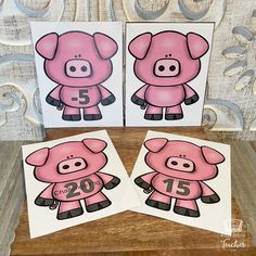 three pink pig cards with numbers on them