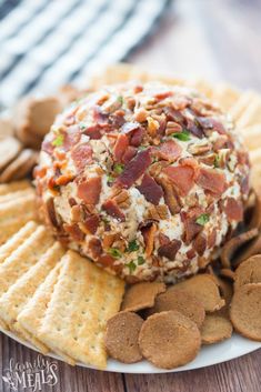 a cheese ball with bacon on top surrounded by crackers