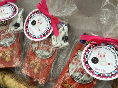 three bags filled with treats sitting on top of a table next to each other in front of a basket