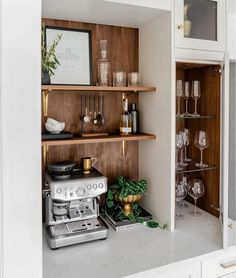 an open cabinet with wine glasses and other items