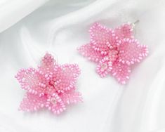 Step into a realm of floral elegance with these exquisite Orchid Pink Beaded Stud Earrings, meticulously handcrafted by a skilled artisan. Each earring is a delicate masterpiece, featuring intricate beadwork that captures the beauty of blooming orchids in full bloom. Indulge in the soft hues of pink, adding a touch of feminine sophistication to any ensemble. These stud earrings are perfect for women who appreciate handmade craftsmanship and timeless design, making them the ideal Mother's Day gif Affordable Pink Flower Beaded Earrings, Elegant Pink Flower Beaded Earrings, Handmade Pink Beaded Earrings For Wedding, Handmade Pink Flower Earrings With Round Beads, Flower-shaped Beaded Earrings With Bead Caps For Gifts, Pink Beaded Flower Earrings As Gift, Handmade Pink Beaded Flower Earrings, Pink Beaded Flower Earrings For Gift, Pink Beaded Earrings With Bead Caps As Gift