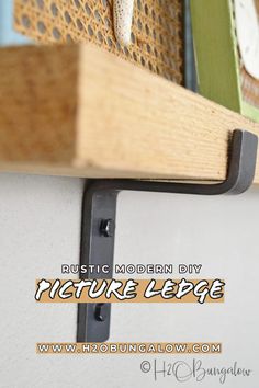 a close up of a wooden shelf with metal brackets on it and the words rustic modern diy picture ledge