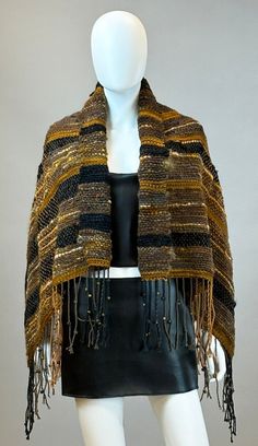 This uniquely designed, one of a kind Root Chakra based art shawl can be used for any occasion!  Dress up or throw on a  pair of boots and jeans.  This shawl has Tiger's Eye beads hand tied into the fringe so you get the added benefit when wearing this grounding wrap.  Tiger's Eye symbolism for the root chakra also encompasses protection and stability.  For the Root Chakra specifically, Tiger's Eye is believed to help establish a strong connection to the earth. This shawl measures 48"x30"+7" fringe per side. Artisan Shawl One Size For Fall, Handmade Shawl For Winter Festival, Traditional Brown Shawl For Fall, Traditional Woven Shawl For Fall, Traditional Brown Scarf For Fall, Handmade Fall Festival Shawl, Traditional Fall Festival Scarves, Artisan Shawl For Fall, Traditional Shawl For Fall, One Size