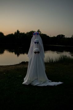 a ghost standing in front of a body of water