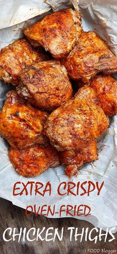 chicken thighs in a basket with the words extra crispy oven fried written on it