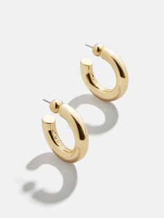 The perfect lightweight chunky gold hoops are just a click away. Our Dalilah Earrings are a must-have jewelry essential for your arsenal. Thick tubes of metal are crafted in a timeless hoop shape and topped off with a comfortable post-back closure. Lightweight and easy to layer (if you so choose), you're bound to reach for these staples again and again. Thick Gold Hoop Earrings, Thick Gold Hoops, Bridal Earrings Studs, Safety Pin Earrings, 18k Gold Earrings, Dope Jewelry, Party Earrings, Jewelry Essentials, Heart Beads