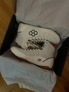 a pair of white sneakers in a box