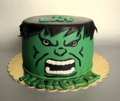 a green cake with an angry face on it