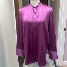 Our Relaxed Silk Satin Blouse Is Enlivened By Double-Layer Raw-Edge Stitching. A Hidden Placket Adds A Smooth Finish. Button-Front Closure. Hidden Placket. Agoya Buttons. Single-Button Split Cuffs. Shirttail Hem. Shoulder Yoke At Back. Hand Wash Cold. Line Dry. Non-Chlorine Bleach And Cool Iron If Needed. Or Dry Clean. 100% Silk. Imported. Chest 41.33 In Hips 43.3 In Length 28.34 In For The Medium Size Pit To Pit 24” Length 29” For The Large Inventory 355,356,357 Long Sleeve Purple Silk Tops, Purple Silk Long Sleeve Tops, Purple Silk Blouse For Workwear, Purple Silk Blouse For Work, Silk Long Sleeve Blouse, Black Bodysuit Longsleeve, Edge Stitching, Linen Tank Top, Blouse Tank Top