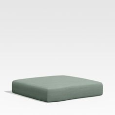 a green square cushion on a white background