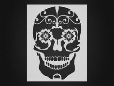 a skull with flowers on it's head is shown in black and white paper