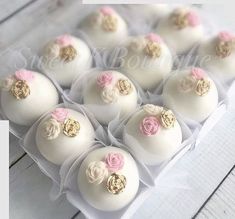 twelve white chocolates decorated with pink and gold flowers