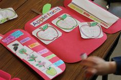 an apple themed bulletin board is displayed on a table