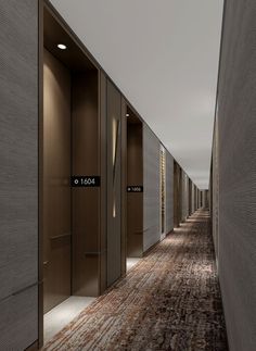 an empty hallway leading to two elevators