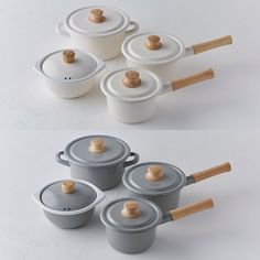 several pots and pans with wooden handles on a white surface, all in different shapes and sizes