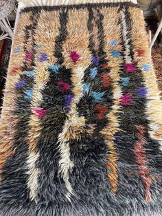 a multicolored area rug on the floor