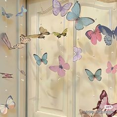 a bunch of butterflies hanging from the side of a door