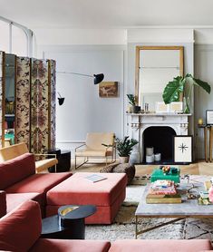 a living room filled with furniture and a fire place in the middle of a room