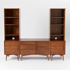 an old wooden dresser with two open shelves and one closed shelf on each side, against a white background