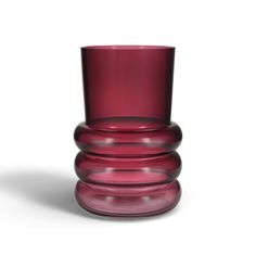 a red glass sitting on top of a white table