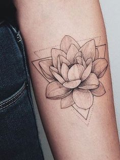 a black and white photo of a flower tattoo on the left arm with geometric shapes around it