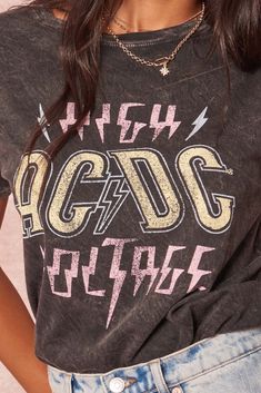 Mineral-washed graphic t-shirt. Vintage-style "AC/DC High Voltage" text print and lightning graphics. Round neckline. Short drop-shoulder sleeves. Loose fit. 100% Cotton. Imported top designed and printed in Los Angeles, CA. Officially licensed AC/DC merchandise. Not eligible for discounts. Acdc Shirt Aesthetic, Acdc Oversized Shirt, Black Acdc Shirt, Acdc Graphic Tee, Rock And Roll Cotton Graphic T-shirt, Text Print, Vintage Canvas, High Voltage, Ac Dc