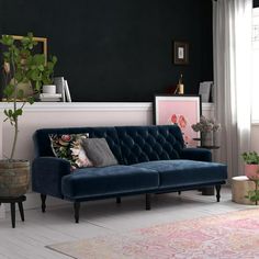 a living room filled with furniture and plants on the floor next to a large window