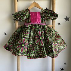 Dress for kids, Handmade in Nigeria,  Stand out from the crowd and express your individuality with a one-of-a-kind African print design. Find a style that reflects your personality, from bold and beautiful dresses to classic shirts and pants. Your purchase empowers the talented artisans of Abia State and helps preserve this special cultural tradition. Bring a touch of African vibrancy and cultural richness to your wardrobe. Order your handmade African print clothing today! Please note: Due to th African Print Clothing, African Children, Handmade African, Shirt And Pants, Classic Shirt, African Print, Kids Dress, Green Dress, Beautiful Dresses