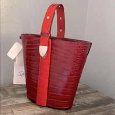 A Classic Anni-Croc Embossed Convertible Bucket Bag From 324 New York! Two Way Magnetic Closure And Adjustable Straps Allow You To Change The Look To Wear On Your Shoulder Or To Carry By The Top Handle. Enough Space For Essentials And Has Two Pockets Inside. 9"H 10.5w 4"D Let Me Know If You Have Any Questions. Red Luxury Bucket Bag With Detachable Handle, Luxury Red Bucket Bag With Detachable Handle, Luxury Red Top Handle Bucket Bag, Luxury Red Bucket Bag With Detachable Strap, Designer Red Rectangular Bucket Bag, Red Bucket Bag With Detachable Handle, Red Bucket Bag With Detachable Top Handle, Red Top Handle Bucket Bag With Detachable Handle, Red Top Handle Bucket Bag For Evening