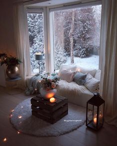 a living room filled with furniture next to a large window covered in frosted trees